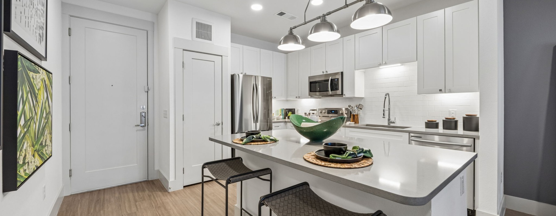 Spacious kitchen with white countertops and cabinets