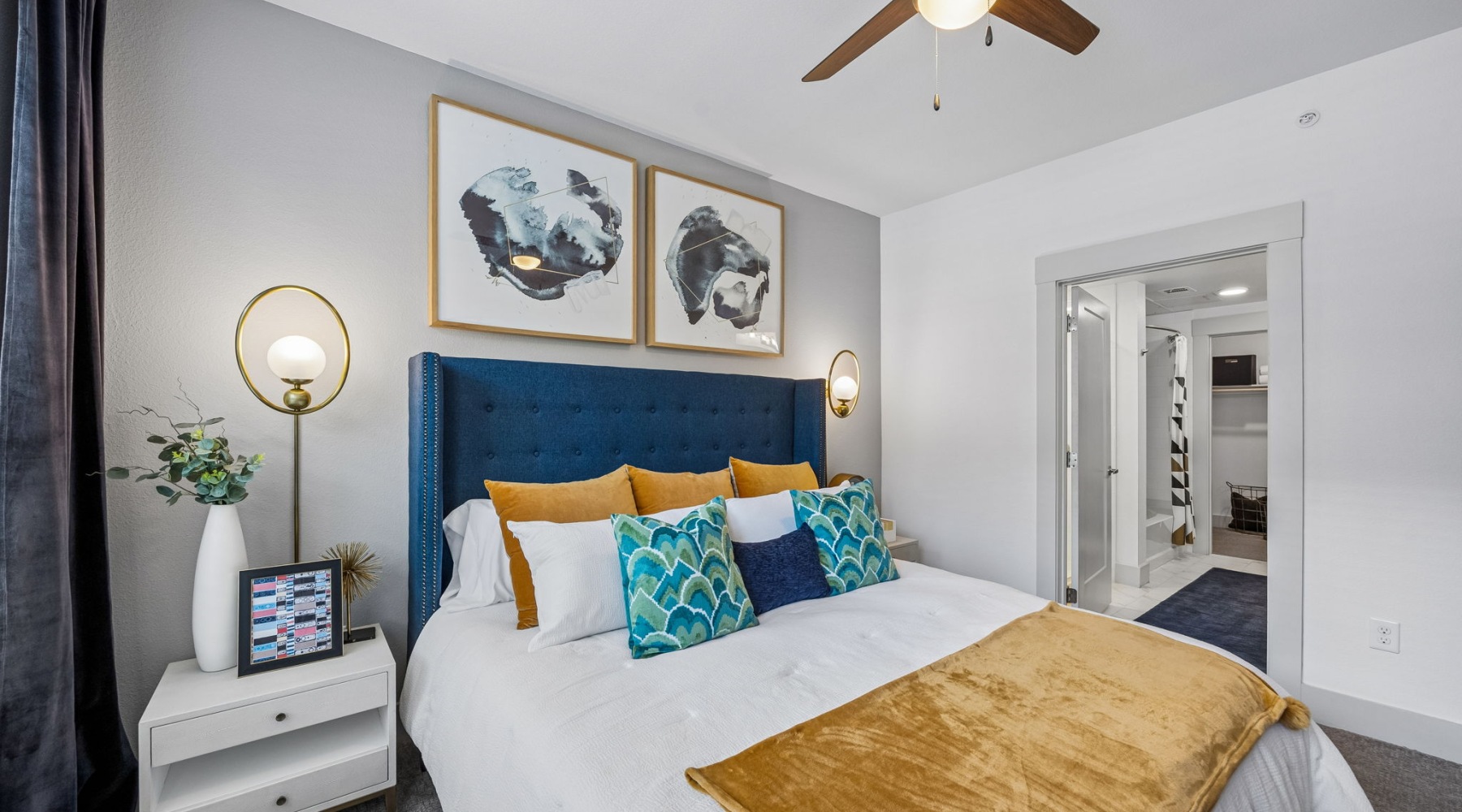 a bedroom with a bed and a fan
