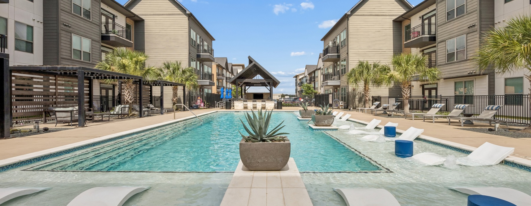 a pool in a courtyard with buildings around it