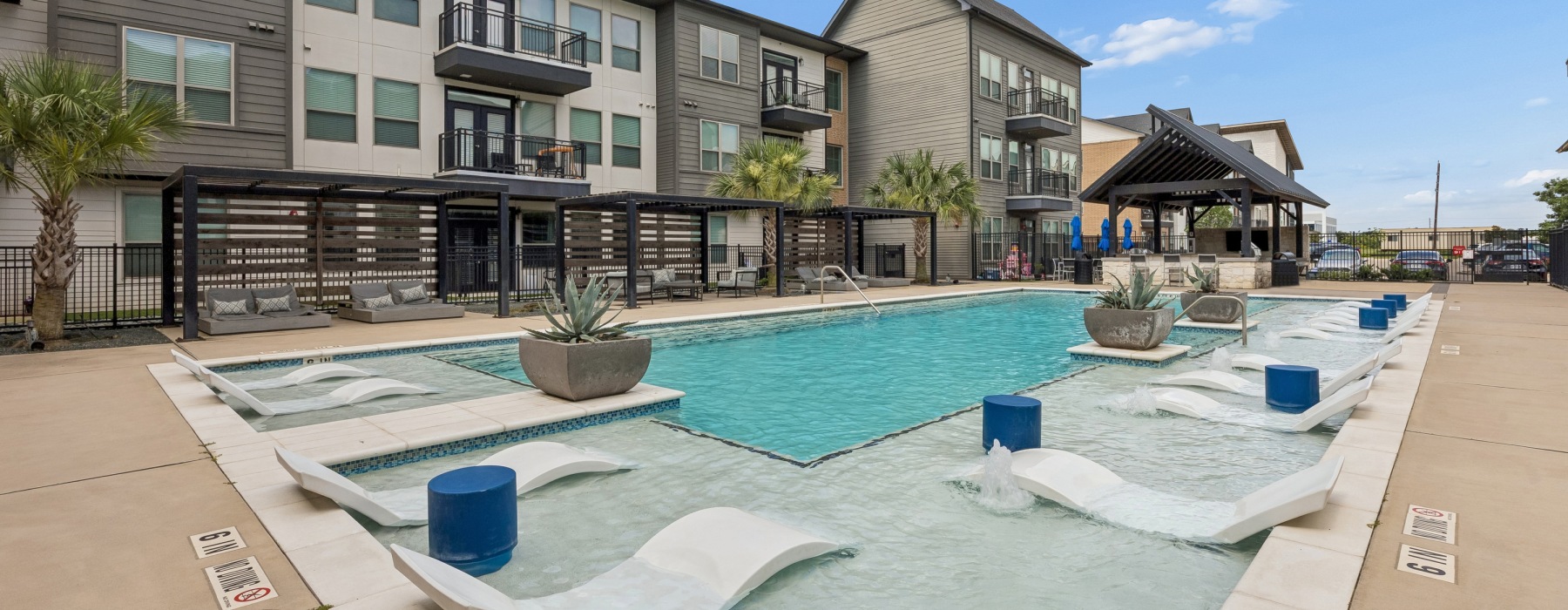 a pool in a courtyard with buildings around it