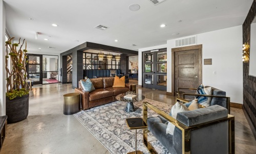 a clubroom with a couch and chairs
