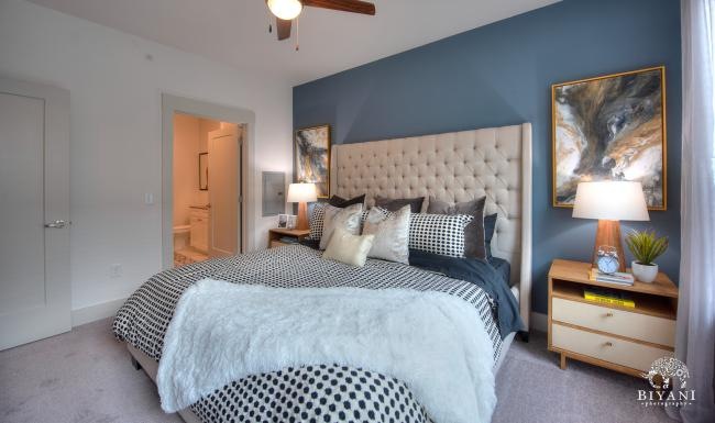 a bedroom with a bed and lamps