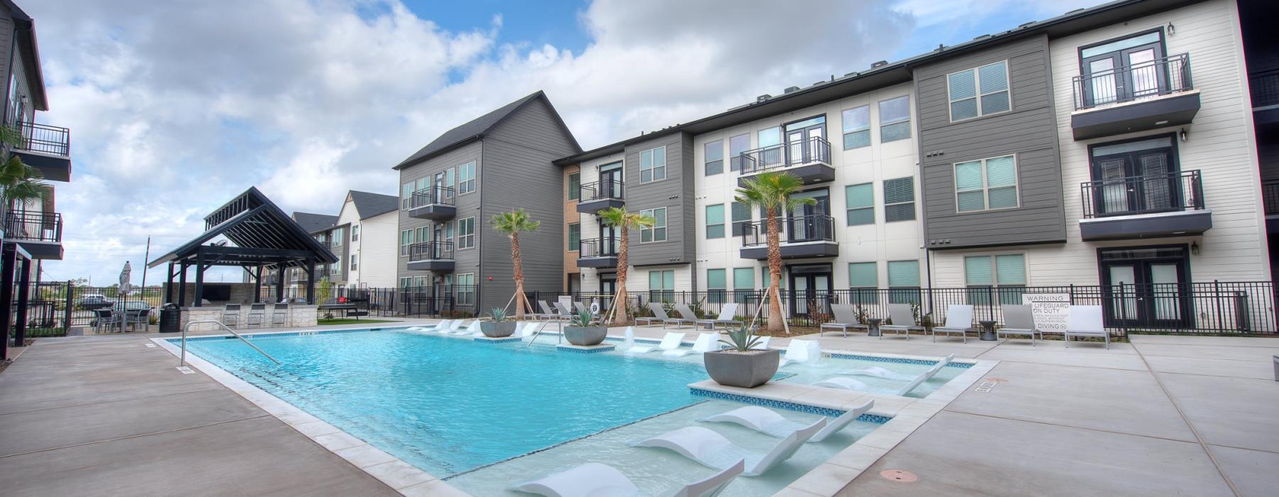 a pool in a courtyard with buildings around it