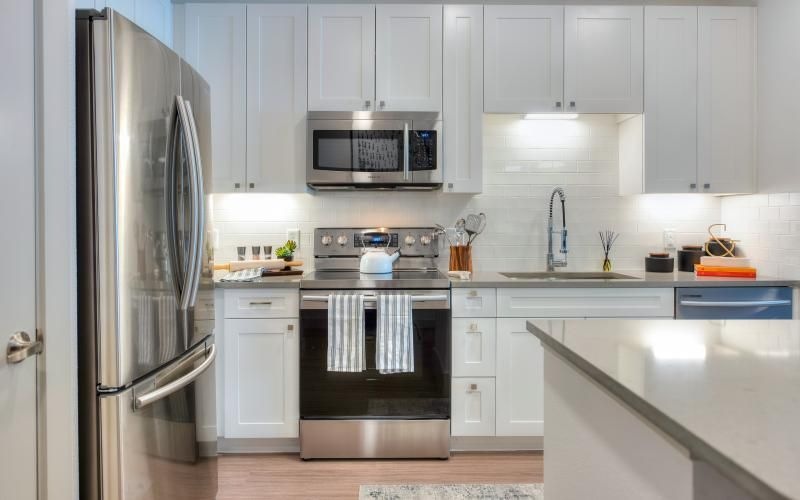 a kitchen with white cabinets