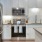 a kitchen with white cabinets