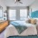 a bedroom with a bed and a fan