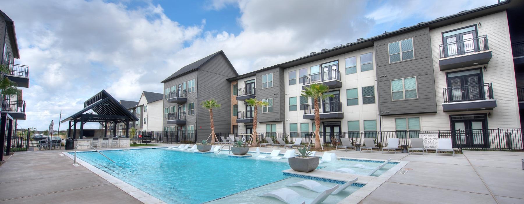 a pool in a courtyard with buildings around it